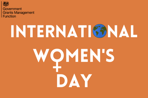 International Women's Day written in upper case on an orange backgroynd. There is an image of the world as a globe in the O in international and the symbol for female in the O for women.